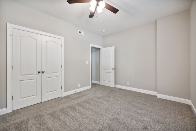 unfurnished bedroom with carpet flooring, a closet, and ceiling fan