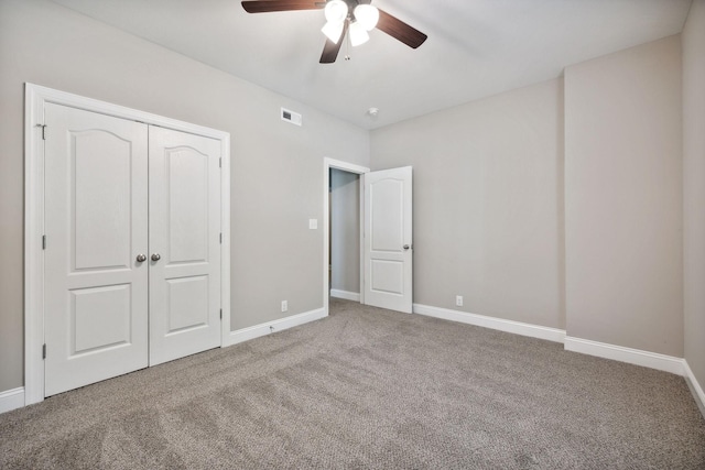 unfurnished bedroom with carpet floors, ceiling fan, and a closet