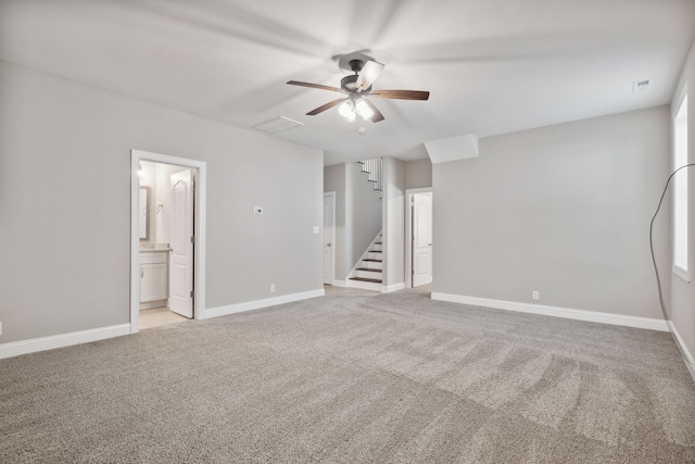 unfurnished room featuring ceiling fan and light carpet