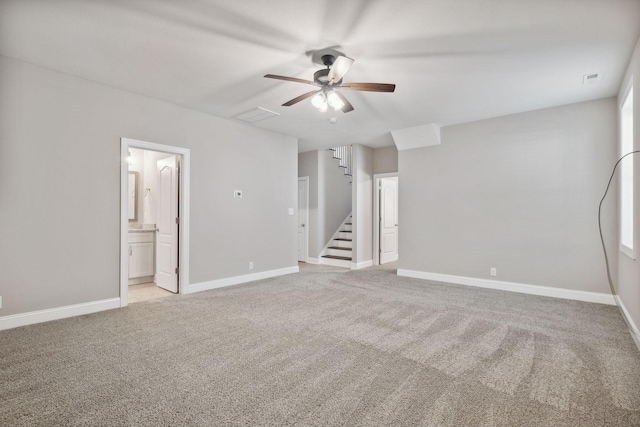 interior space with light colored carpet and ceiling fan