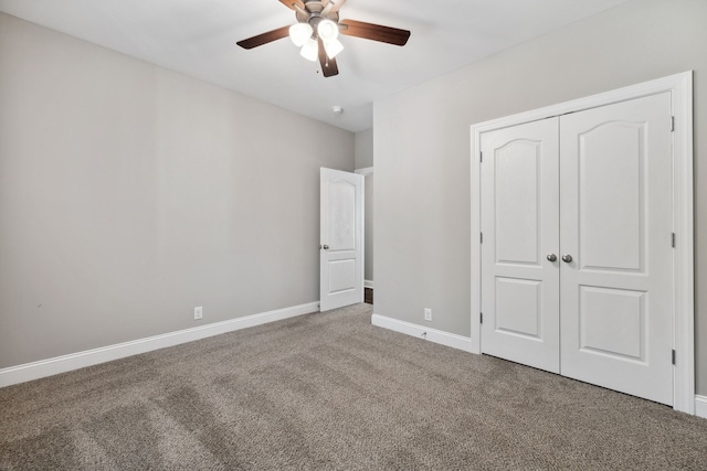 unfurnished bedroom featuring ceiling fan, a closet, and carpet