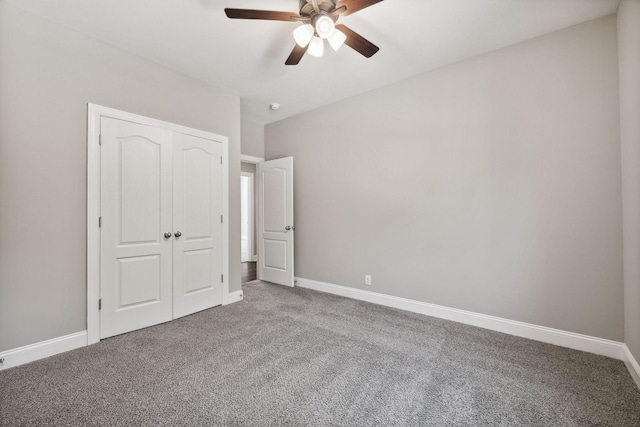 unfurnished bedroom with ceiling fan, a closet, and carpet