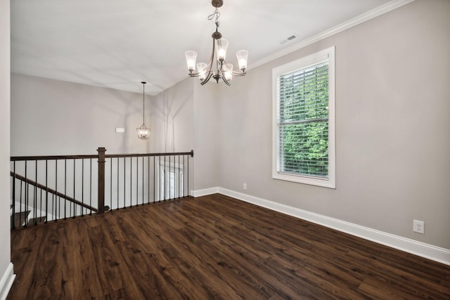 spare room with ornamental molding, hardwood / wood-style floors, and an inviting chandelier