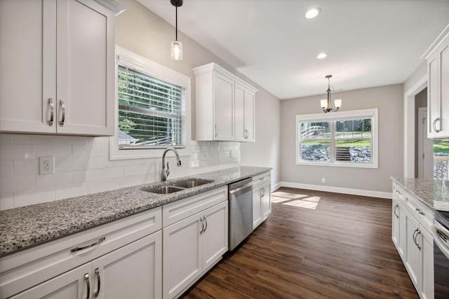 kitchen with white cabinetry, sink, hanging light fixtures, and appliances with stainless steel finishes