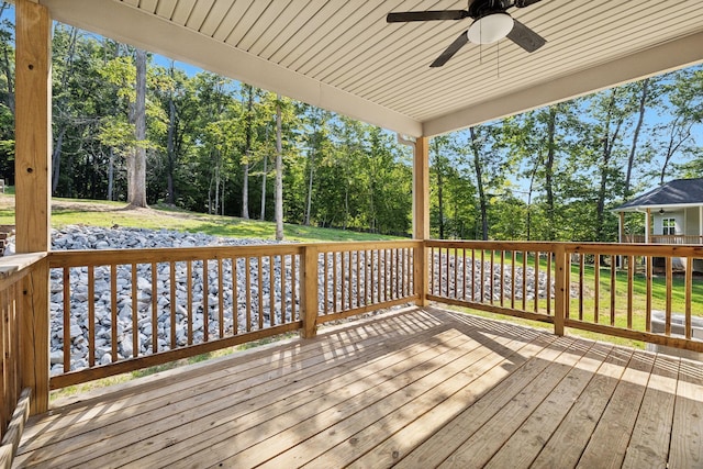 deck featuring a lawn and ceiling fan