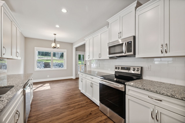 kitchen featuring appliances with stainless steel finishes, white cabinets, dark hardwood / wood-style floors, and decorative backsplash