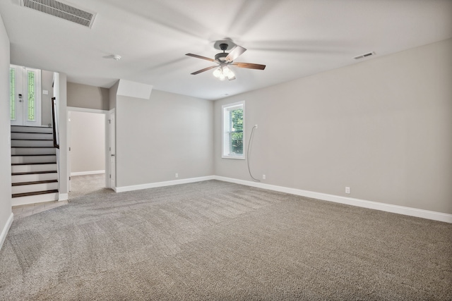 carpeted spare room with ceiling fan