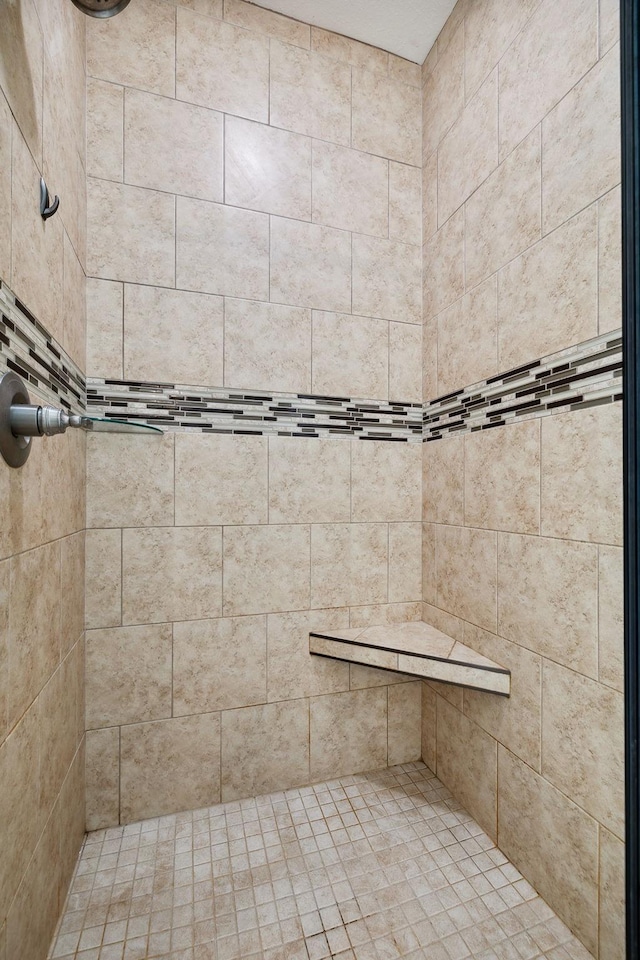 bathroom with tiled shower