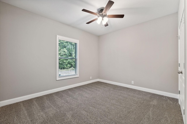 carpeted spare room featuring ceiling fan