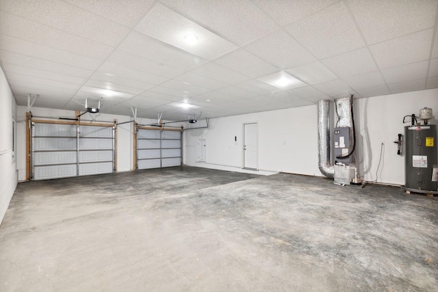 garage with a garage door opener, electric water heater, and heating unit