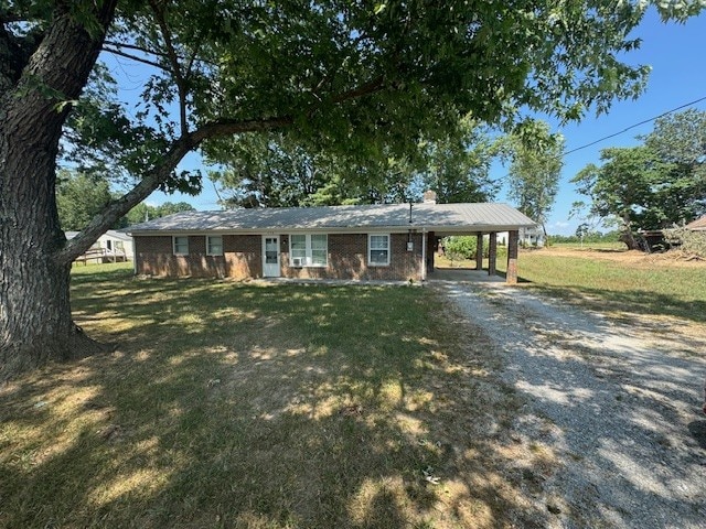 single story home featuring a carport and a front yard