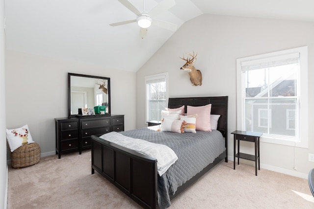 bedroom with ceiling fan, light colored carpet, and lofted ceiling