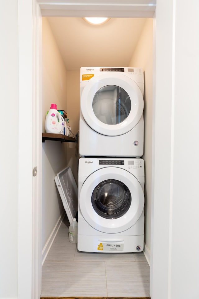 laundry area featuring stacked washer and clothes dryer