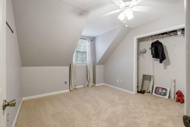 bonus room featuring ceiling fan, light colored carpet, and lofted ceiling