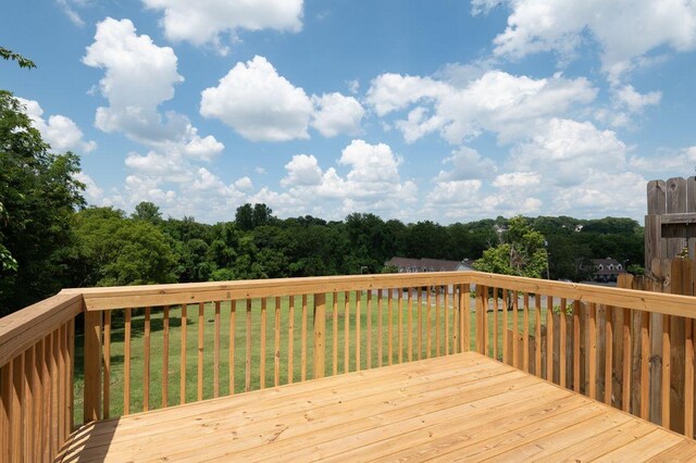 wooden deck featuring a yard