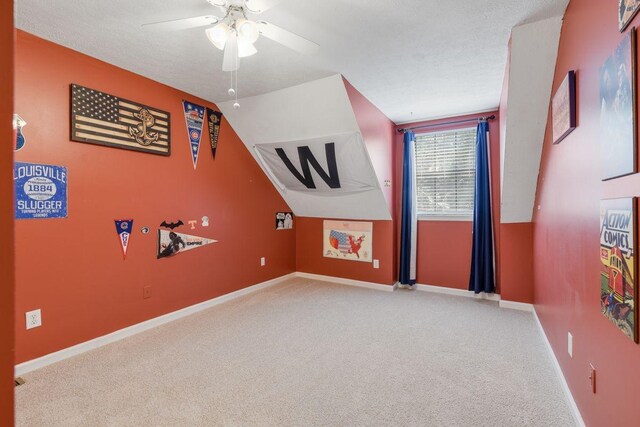 bonus room featuring vaulted ceiling, light colored carpet, and ceiling fan