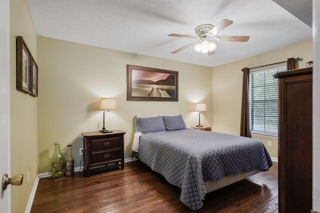 bedroom featuring ceiling fan and dark hardwood / wood-style flooring