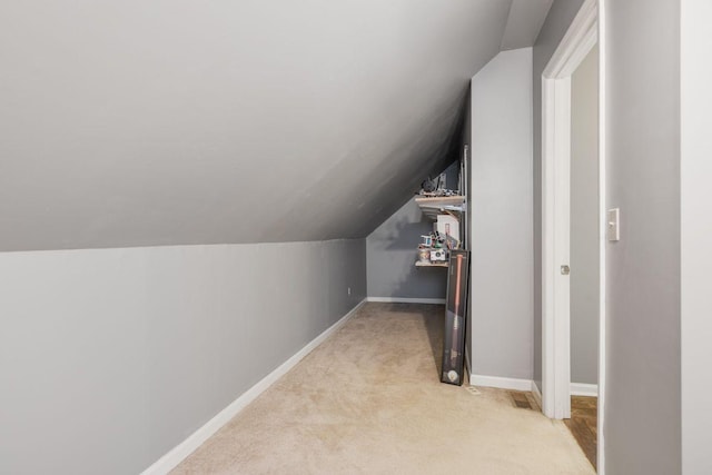 additional living space with lofted ceiling and light carpet