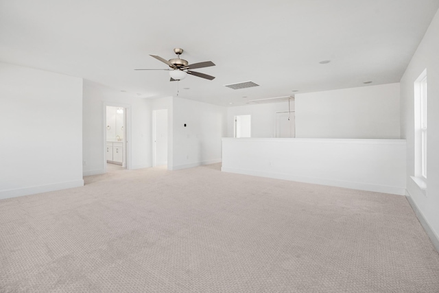 empty room featuring light colored carpet and ceiling fan