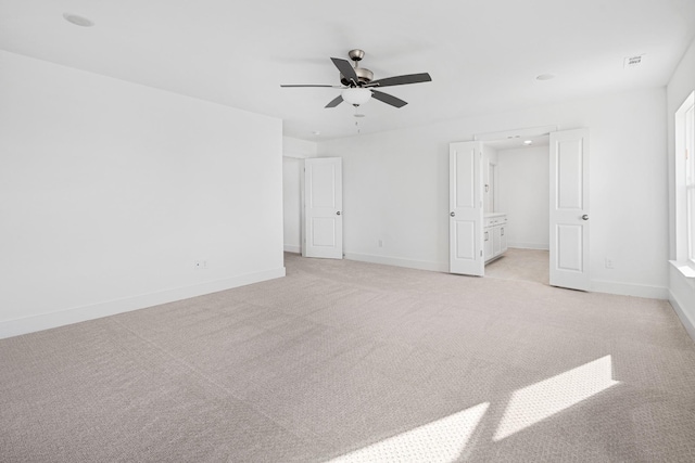 unfurnished bedroom featuring light carpet and ceiling fan