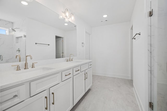 bathroom with vanity and a shower with shower door