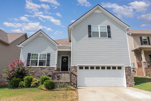 view of front of house with a garage and a front lawn