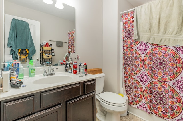 bathroom featuring vanity, tile patterned flooring, and toilet