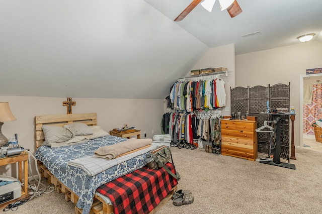 carpeted bedroom featuring vaulted ceiling and ceiling fan