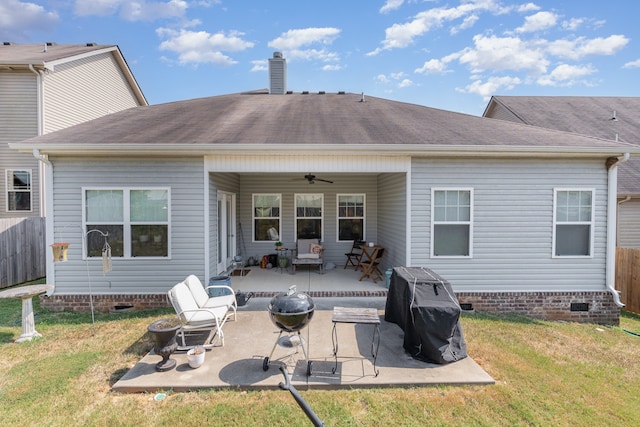 back of property with a patio, a yard, and ceiling fan