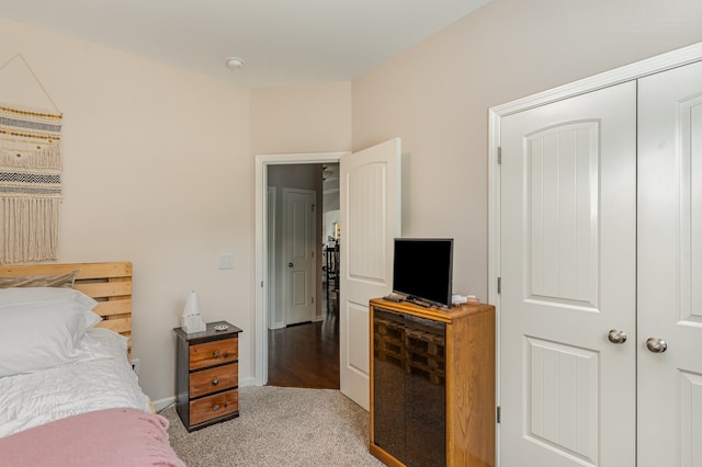 bedroom featuring light colored carpet and a closet