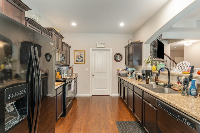 kitchen featuring dark brown cabinetry, sink, dark hardwood / wood-style flooring, and black appliances