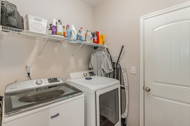 clothes washing area with washing machine and clothes dryer