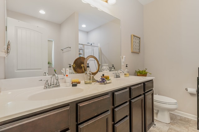 bathroom featuring tile patterned flooring, dual vanity, and toilet