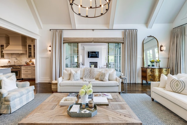 living room with dark hardwood / wood-style flooring, lofted ceiling with beams, and a chandelier