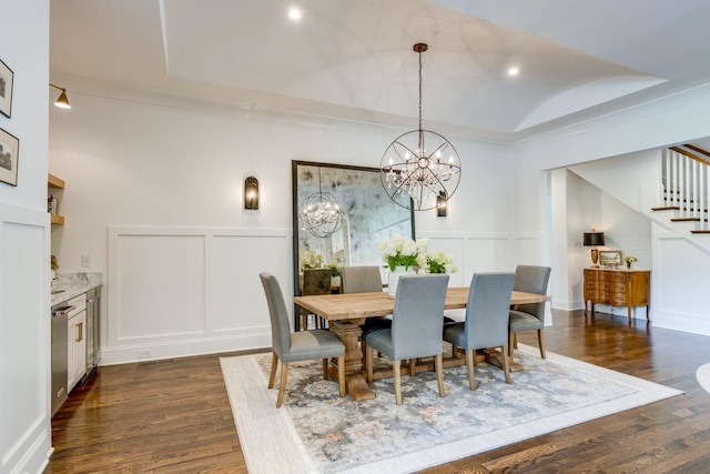 dining area featuring dark wood-type flooring, ornamental molding, lofted ceiling, and a notable chandelier