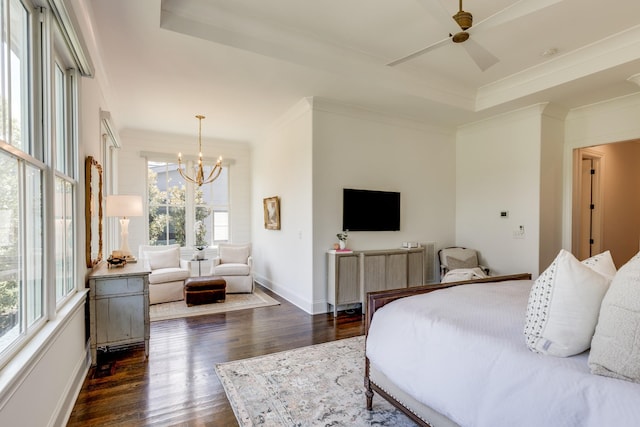 bedroom with crown molding, dark hardwood / wood-style flooring, a raised ceiling, and an inviting chandelier