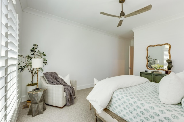 carpeted bedroom with ornamental molding and ceiling fan