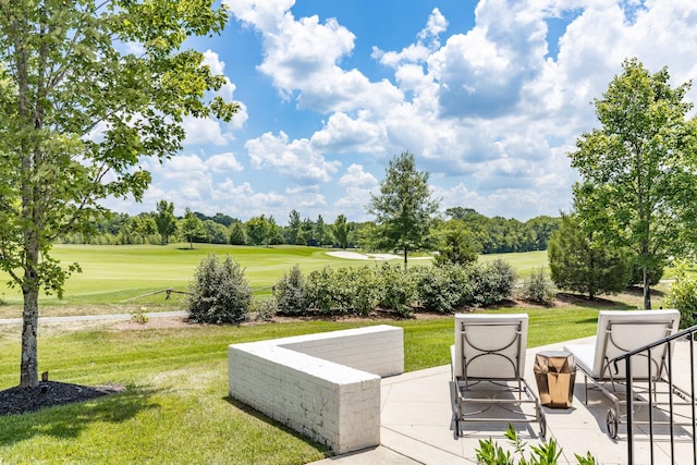 view of home's community featuring a yard and a patio area