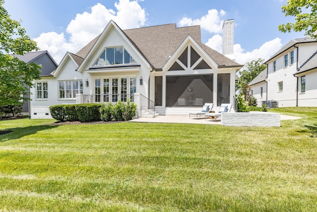 rear view of house featuring cooling unit, a sunroom, a yard, and a patio