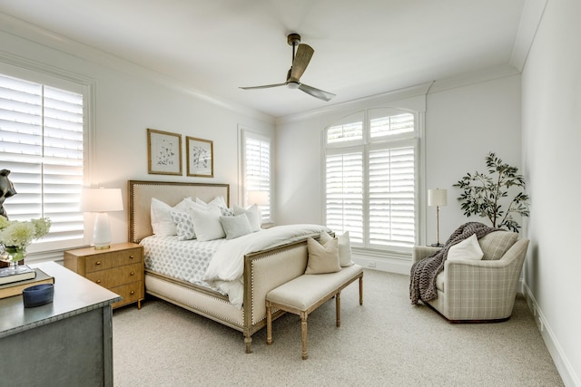 carpeted bedroom featuring ornamental molding and ceiling fan