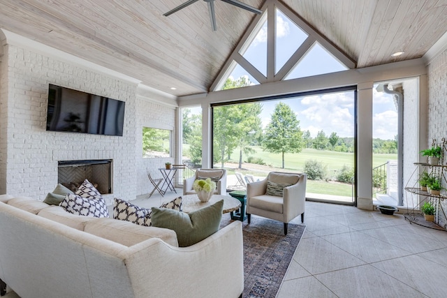 sunroom with ceiling fan, lofted ceiling, a fireplace, and wooden ceiling