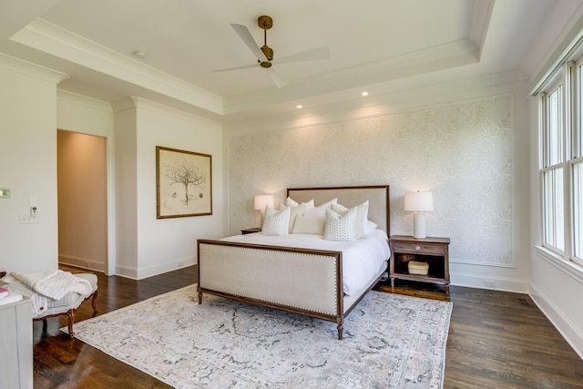 bedroom with crown molding, ceiling fan, dark hardwood / wood-style floors, and a raised ceiling