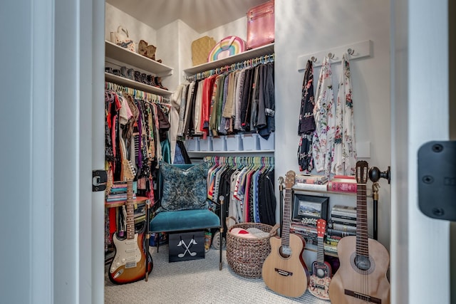 walk in closet with carpet