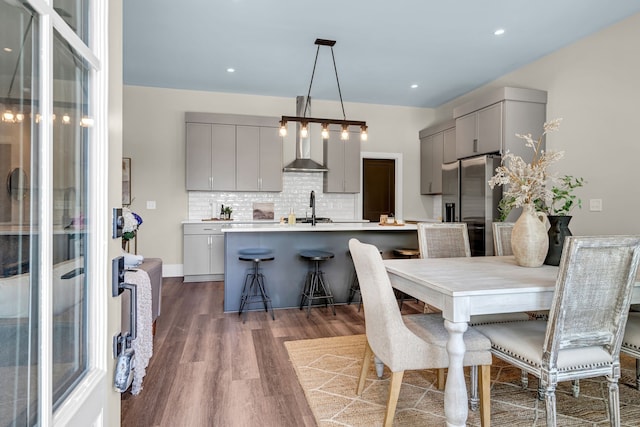 dining area featuring sink and dark hardwood / wood-style flooring