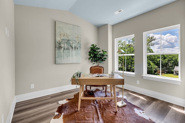 office space featuring dark wood-type flooring, a healthy amount of sunlight, and vaulted ceiling