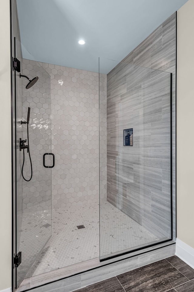 bathroom featuring a shower with shower door