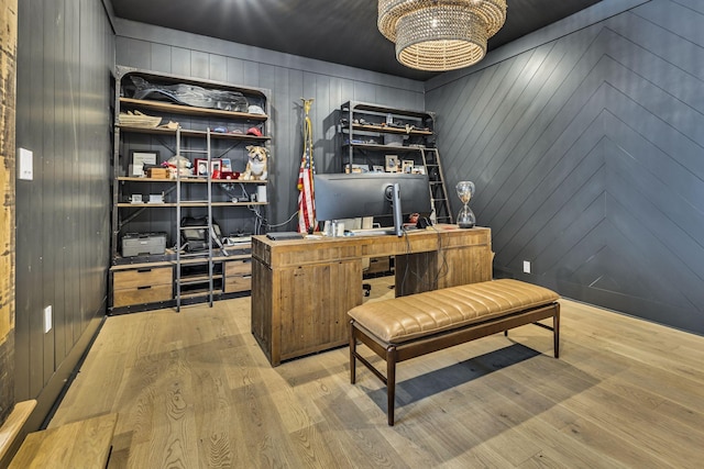 office with an inviting chandelier and light hardwood / wood-style flooring