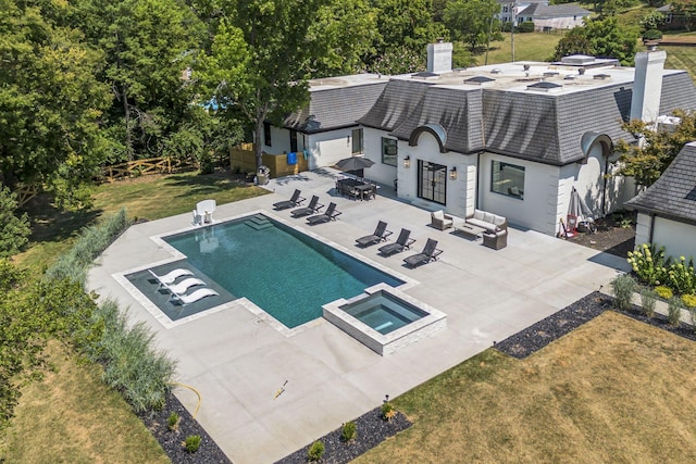 view of swimming pool with an in ground hot tub, a patio area, and a lawn