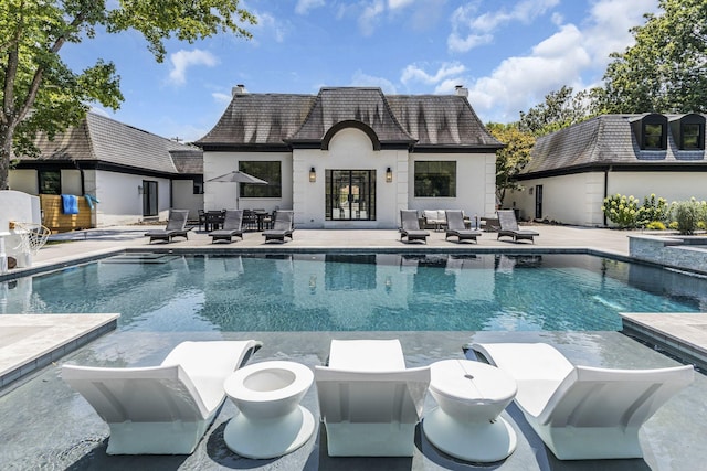 view of swimming pool featuring an outdoor structure and a patio