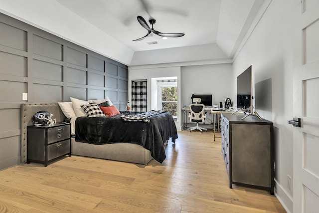 bedroom featuring ceiling fan, vaulted ceiling, and light wood-type flooring